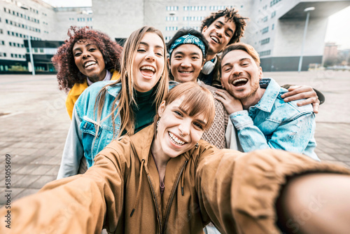 Group multiracial friends taking selfie picture with mobile smartphone outside school - Young diverse people celebrating laughing together - Portrait photo of teens guys and girls enjoying vacation