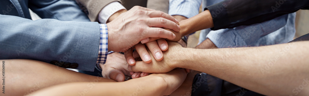 Top view of group multi ethnic coworkers stacked hands together as concept of corporate unity Top view of group multi ethnic coworkers stacked hands together as concept of corporate unity