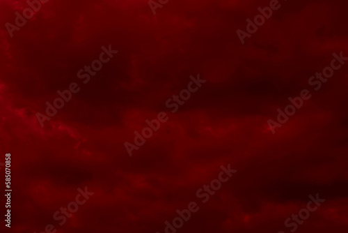 Red cloudy night sky background. Blurred photo of dark red sky. Photo can be used for the concept of galaxy space New Year, Christmas and Halloween backgrounds.
