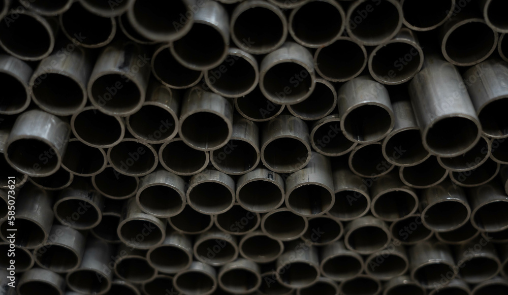 Stack of steel pipes. Close - up of stack of metal pipes. Industrial elements closeup. Parts stacked for further processing. Stack of steel pipes. Close - up of stack of metal pipes. Industrial elements closeup. Parts stacked for further processing.