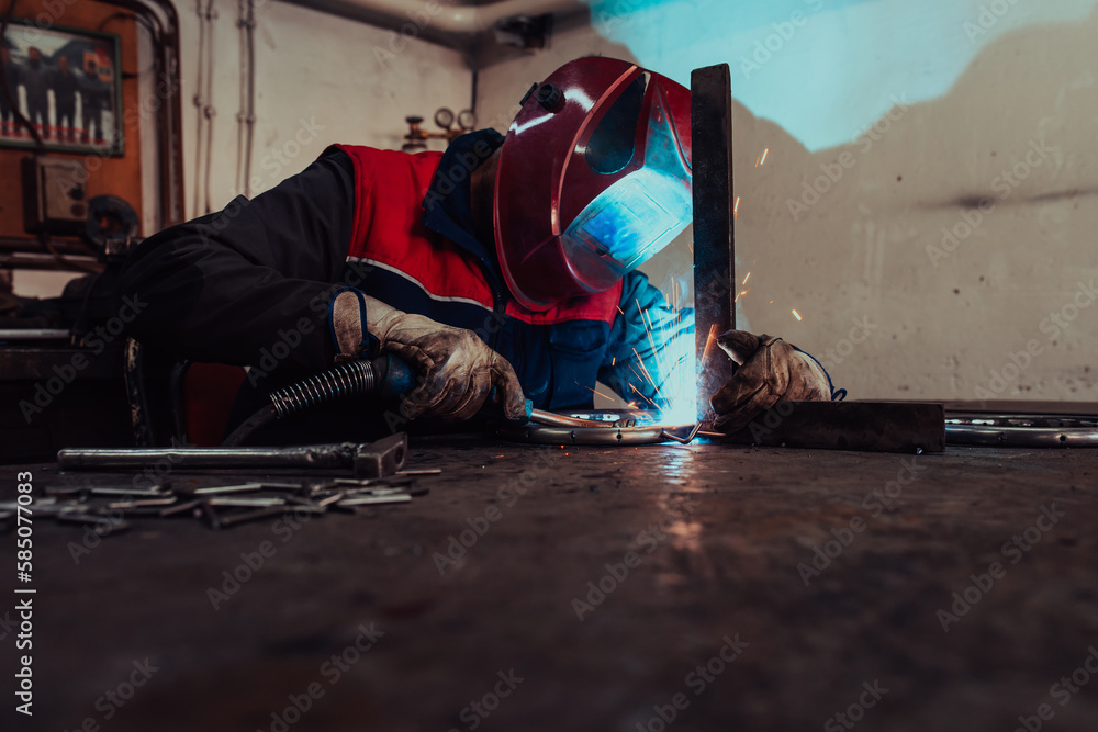 Obraz premium Welder erecting technical steel. Industrial steel welder in factory technical