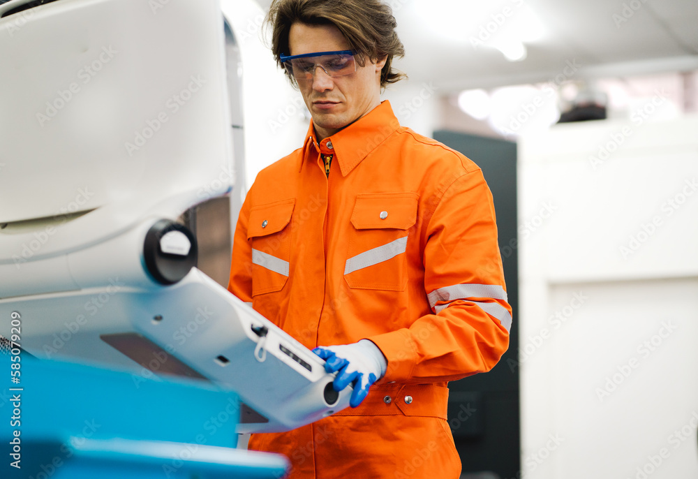 Industrial engineer operating automated part machining in metal engineering factory. CNC specialist working on precision cutting steel technology in metalwork manufacturing. Digital machinery industry Industrial engineer operating automated part machining in metal engineering factory. CNC specialist working on precision cutting steel technology in metalwork manufacturing. Digital machinery industry
