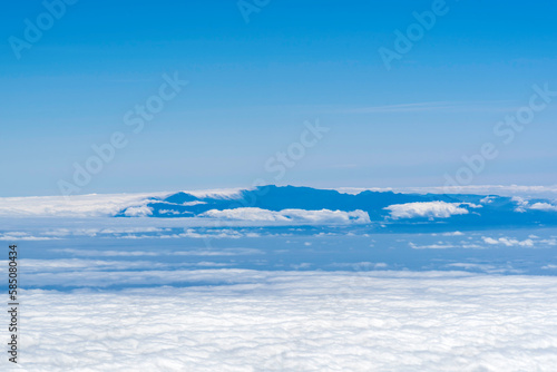 View from above the clouds on mountains far away © Julija