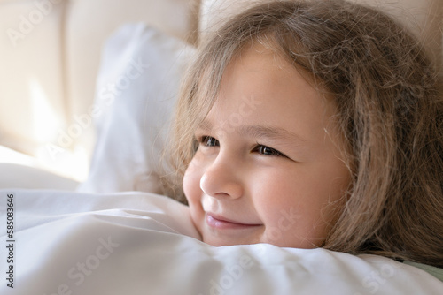 Cute Smiling Little Girl Woke up in White Bed. Morning in Wekeend. Flat Lay.