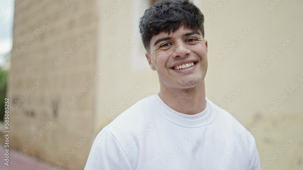Young hispanic man smiling confident standing at street Young hispanic man smiling confident standing at street