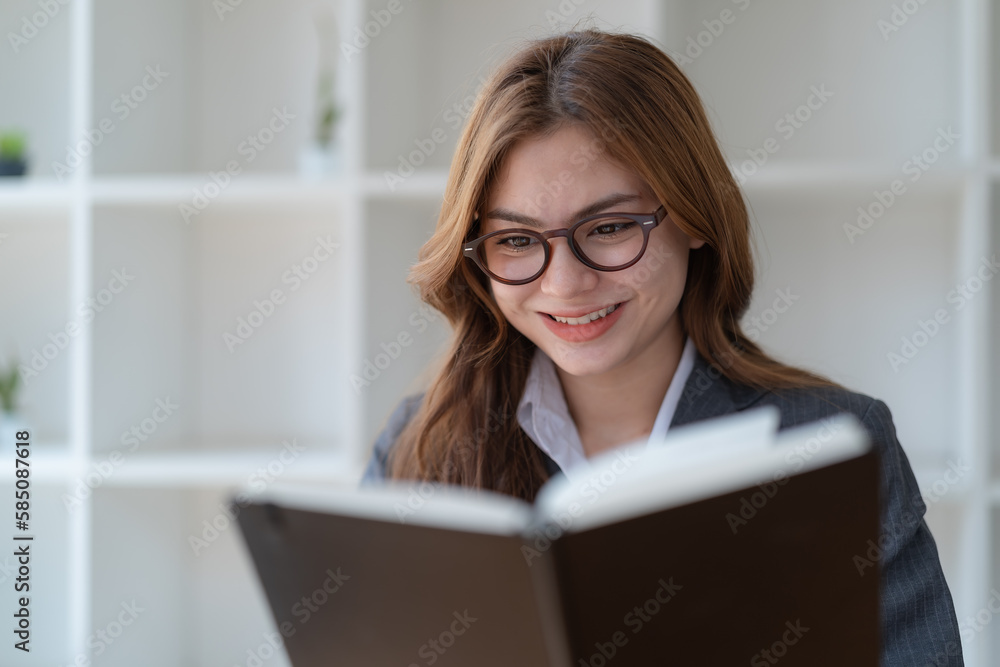 Close-up pretty young woman with glasses reading a book. Close-up pretty young woman with glasses reading a book.