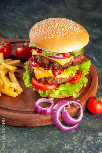 delicious homemade burger of beef, cheese and vegetables on an table. Fat unhealthy food close-up, burger with cheese, bacon, salad and vegetables on wooden board, hamburger with lettuce, cheeseburger