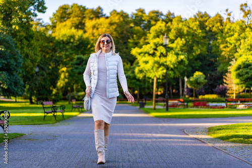 Beautiful woman walking in city park  © Jacek Chabraszewski