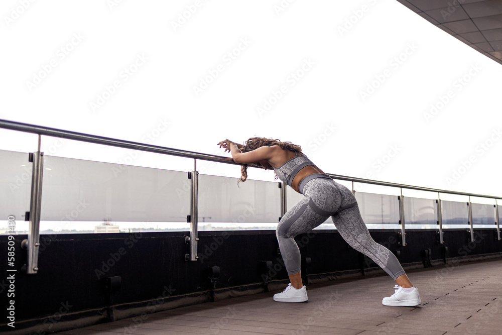 Fit woman exercise on terrace and feel so good