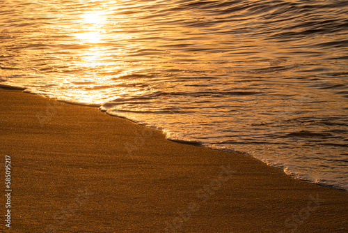 Sun reflecting off waves and sand along a beach in Florida
