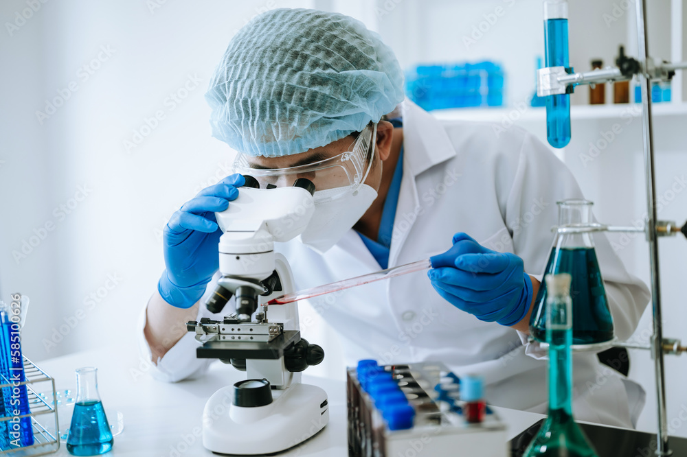Male scientist researcher conducting an experiment in laboratory.. Male scientist researcher conducting an experiment in laboratory..