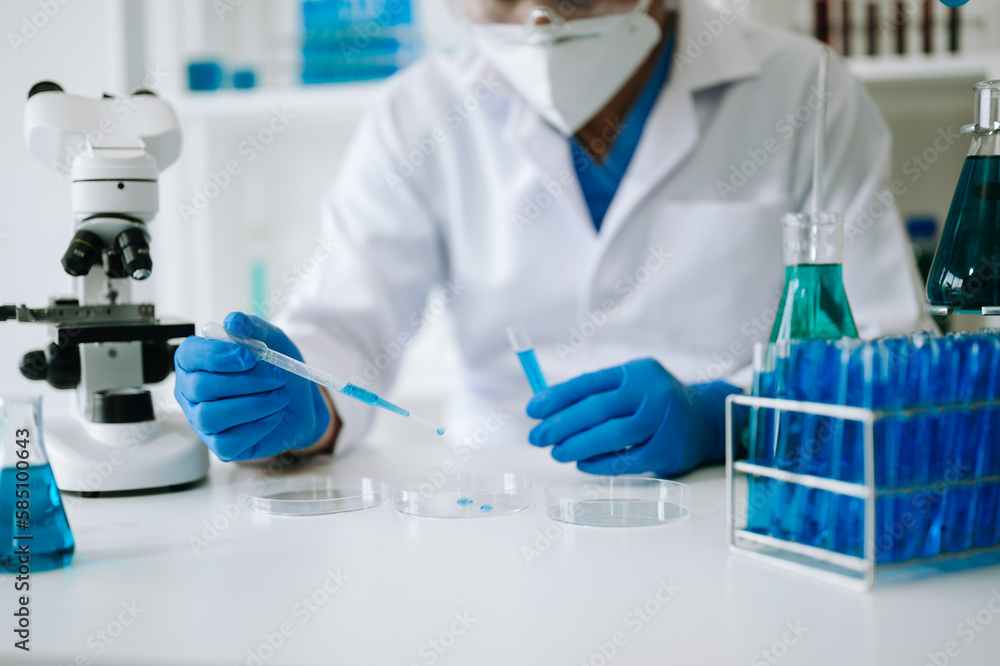 Scientist mixing chemical liquids in the chemistry lab. Researcher working in the chemical a laboratory.. Scientist mixing chemical liquids in the chemistry lab. Researcher working in the chemical a laboratory..