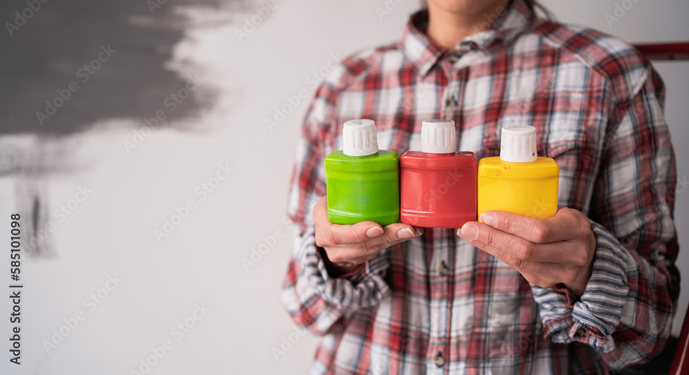 Hands of house painter woman decorator choose the color dye, work of the house to renovate, close up. Renovation Hands of house painter woman decorator choose the color dye, work of the house to renovate, close up. Renovation