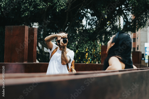 Photograph of man taking pictures with a camera of a girl. Concept of vacation, tourism, and lifestyle.