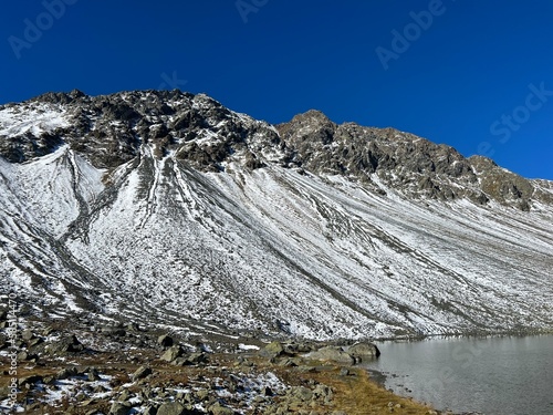 First snow on the rocky mountain peak Chlein Schwarzhorn (2967 m) in the Albula Alps and above the Swiss mountain road pass Fluela (Flüelapass), Davos - Canton of Grisons, Switzerland (Schweiz) photo