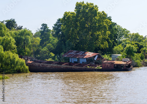 Abandoned and rotting tour or cruise boat on banks of Parana delta near Tigre Argentina