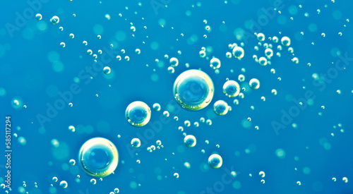 Underwater background of clear blue water with oxygen bubbles closeup
