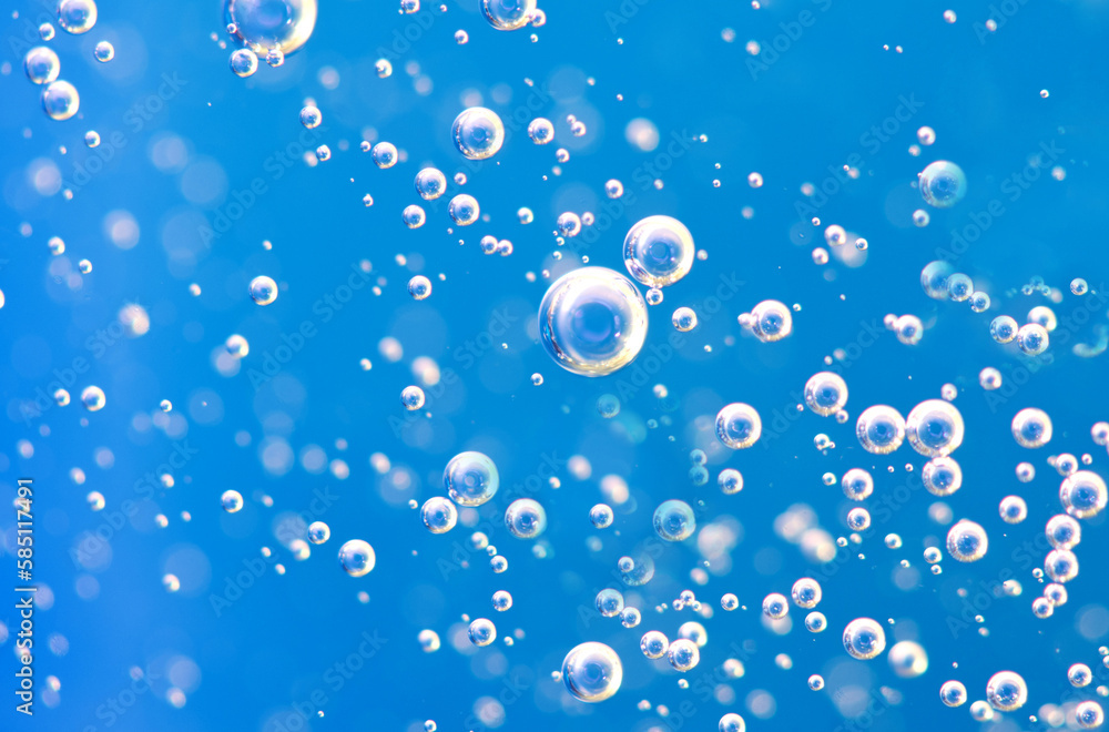 Underwater background of clear blue water with oxygen bubbles closeup