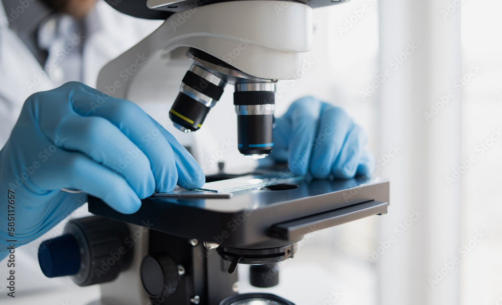 Medical laboratory, scientist hands using microscope for examining samples and liquid, Scientific and healthcare research background Medical laboratory, scientist hands using microscope for examining samples and liquid, Scientific and healthcare research background
