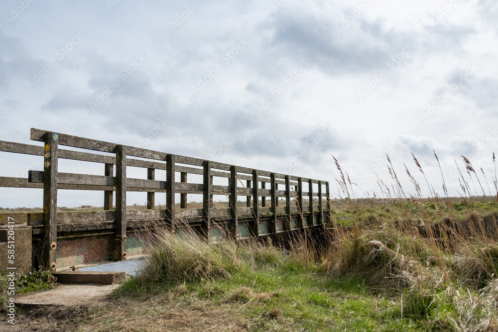 Fototapeta premium Bridge over the river on the Suffolk Coast Path