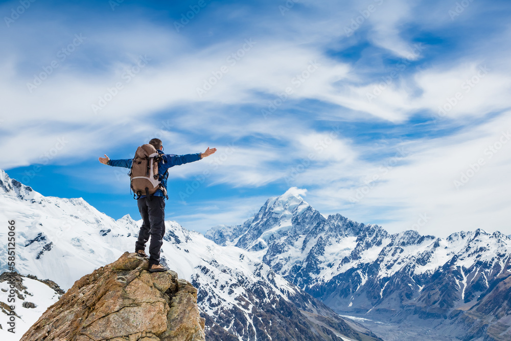 Hiker on the mountain top with his hands outstretched. Sport and active life concept Hiker on the mountain top with his hands outstretched. Sport and active life concept