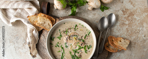a plate with champignon soup on a light table