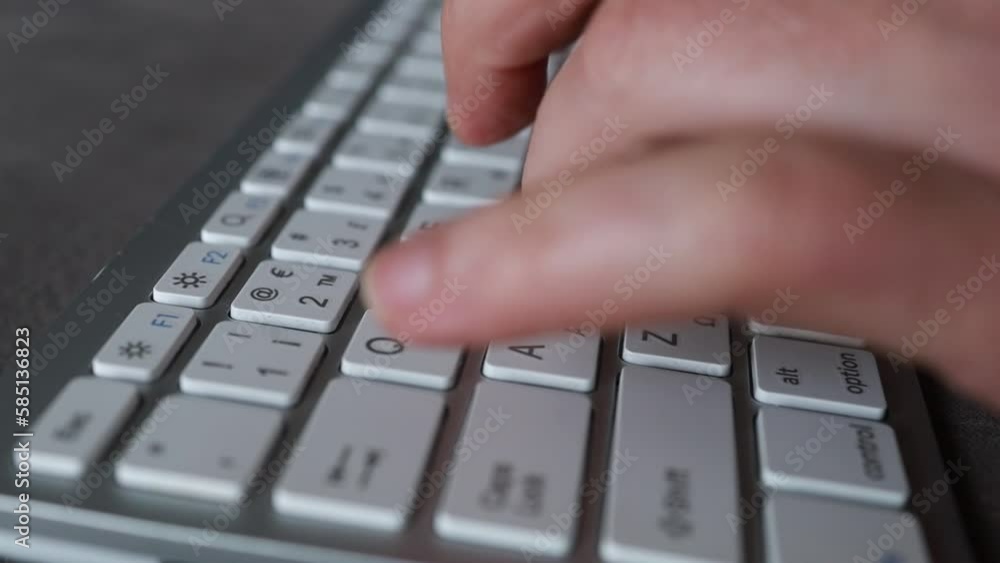 Close-up of male hands typing on keyboard indoors. Businessman working in office or student browsing information Close-up of male hands typing on keyboard indoors. Businessman working in office or student browsing information