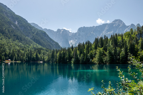 Fototapeta Naklejka Na Ścianę i Meble -  View of Lago Inferiore die Fusine in the Julian Alps of northeastern Italy with the dramatic rock face of Mount Mangart in the background
