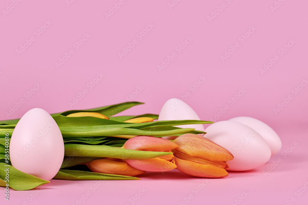 Tulip spring flowers and pink Easter eggs on pink background with copy space Tulip spring flowers and pink Easter eggs on pink background with copy space