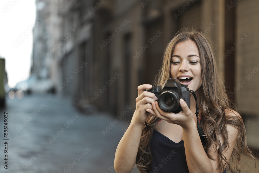portrait of a young woman while taking a photograph