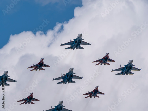 MOSCOW, RUSSIA - MAY 7, 2021: Avia parade in Moscow. group jet fighter aircraft MiG-35 and Su-30 in the sky on parade of Victory in World War II in Moscow, Russia photo