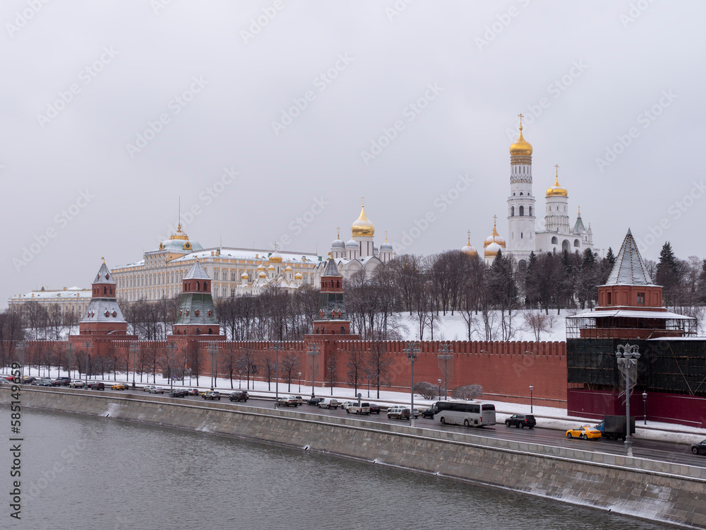 MOSCOW, RUSSIA - December 22, 2022: View of the Moscow Kremlin from the Moscow river. Red brick towers and Bell Tower Of Ivan The Great