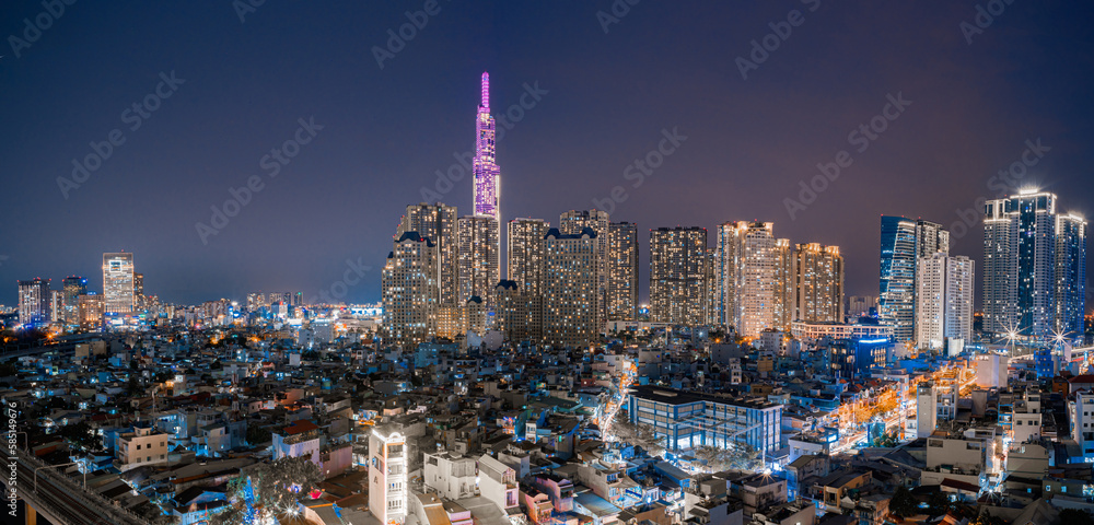 Beautiful aerial view at night in Ho Chi Minh City, see the Landmark 81 tower, the tallest tower in Vietnam. Subway track tracks below. Travel concept