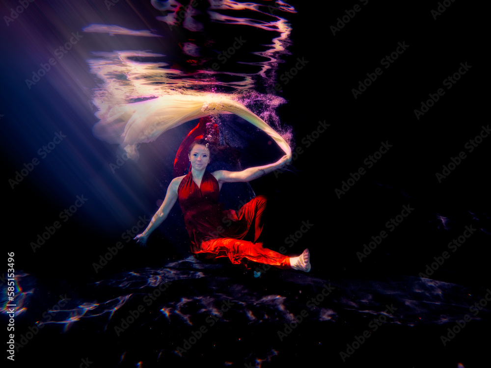 Patty underwater in long red dress