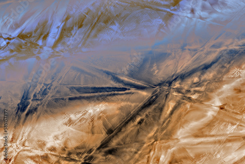 abstract background coppery and blue suggesting folds satiny fabric