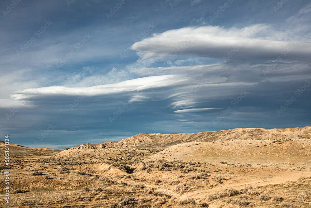 Lenticular clouds over the Bighorn Basin desert landscape in the northwest wilderness of Wyoming. 