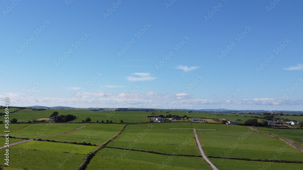 Clear blue sky over the green fields of southern Ireland. Picturesque summer landscape, sunny day. Green grass field under blue sky Clear blue sky over the green fields of southern Ireland. Picturesque summer landscape, sunny day. Green grass field under blue sky