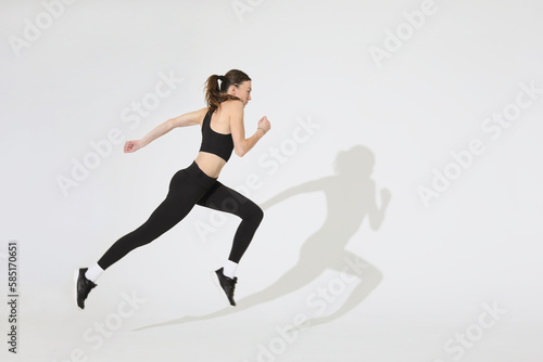 young woman run isolated on white background, side view