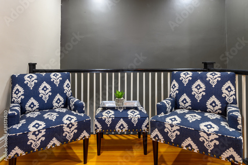 A conversation nook against a railing and grey wall