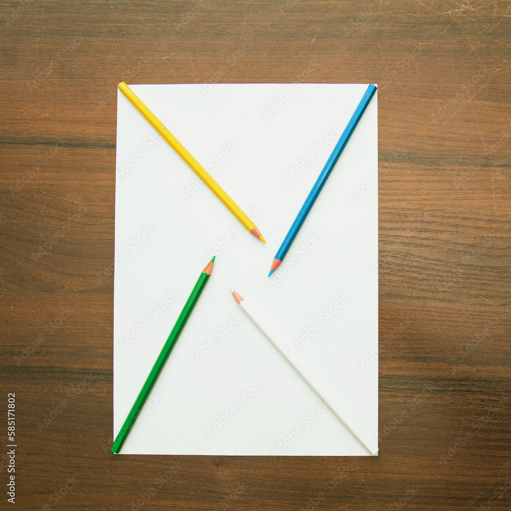 A pencil lies on a blank sheet of paper on a beautiful background in a photo studio A pencil lies on a blank sheet of paper on a beautiful background in a photo studio