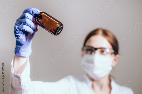 Female medicine doctor hand hold jar of pills