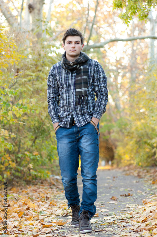 Young handsome teenage man in autumn park Young handsome teenage man in autumn park