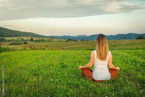 Wallpaper Mural Woman doing yoga on the green grass at the mountain. Carpathians Torontodigital.ca