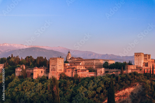 Sunset over Alhambra Palace and the Sierra Nevada mountains in Granada, Andalucia,  Spain