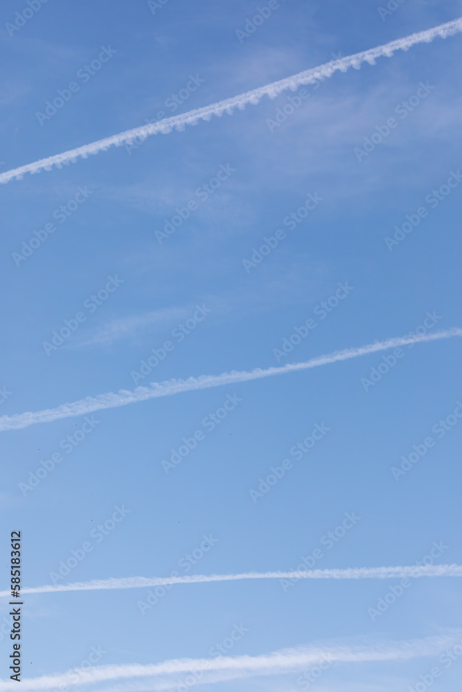 Spectacular chemtrails on a clear blue sky day, chemical trails from planes: a controversial topic Spectacular chemtrails on a clear blue sky day, chemical trails from planes: a controversial topic