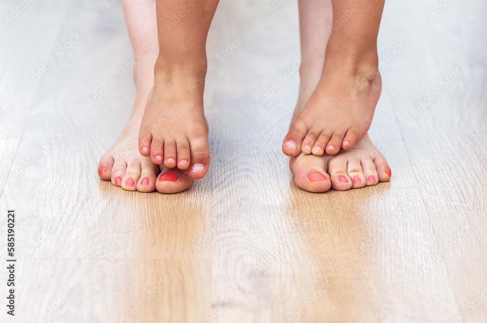 Shot of an unrecognizable mother's feet and her child's feet at home Shot of an unrecognizable mother's feet and her child's feet at home