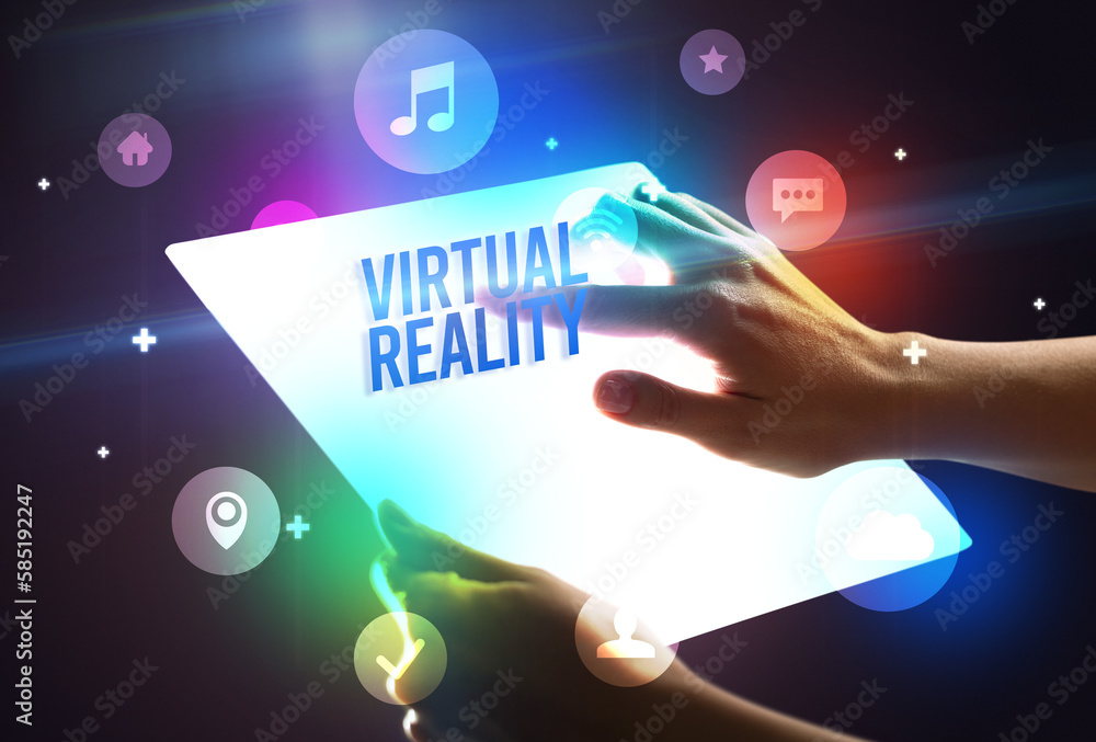 Holding futuristic tablet, new media concept Holding futuristic tablet, new media concept