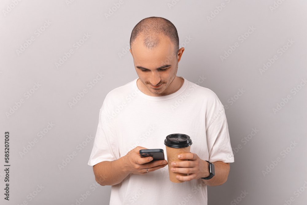 Looking down bald man takes a break surfing the internet and enjoying coffee. Looking down bald man takes a break surfing the internet and enjoying coffee.