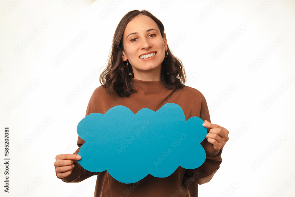 Cheerful young woman holding a blue cloud shaped speech bubble with copy space. Cheerful young woman holding a blue cloud shaped speech bubble with copy space.