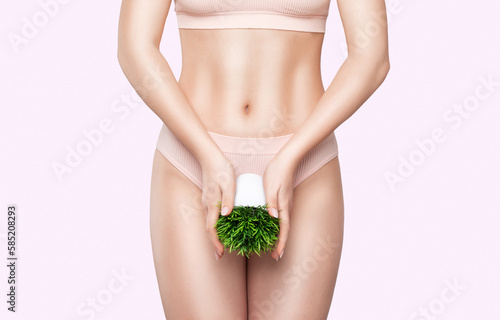 Women Health. A slender woman in white underwear with a green flower. rejuvenation in a beauty salon. Removing unwanted body hair.